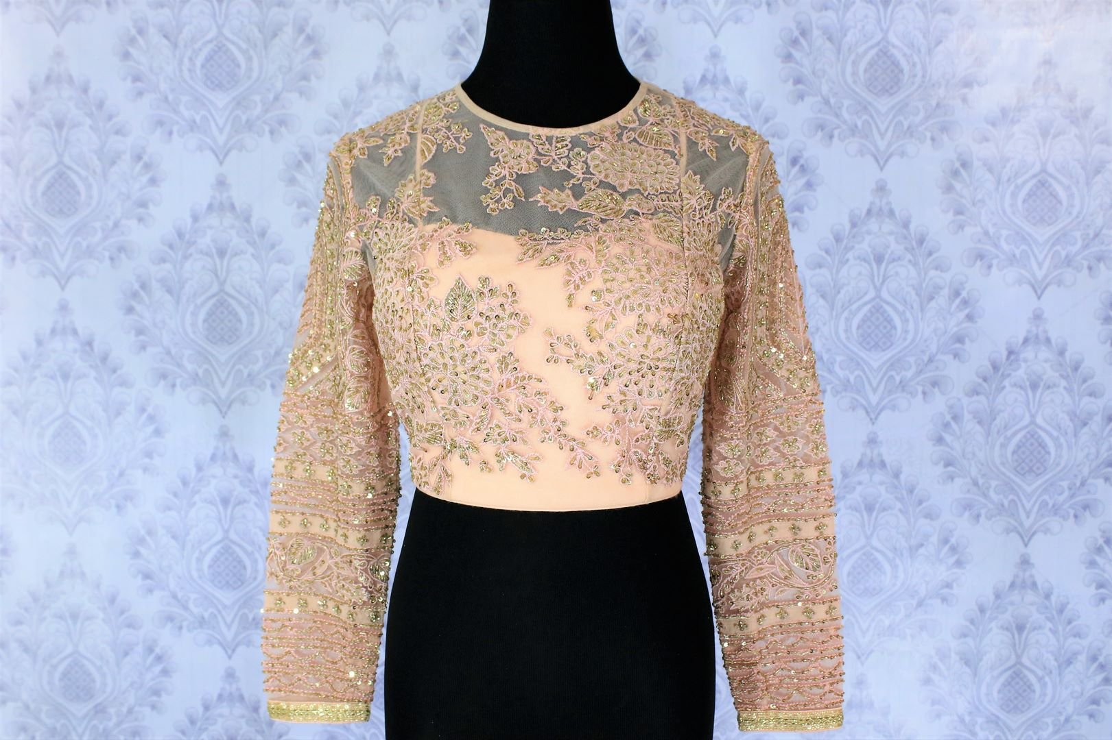 Sizzle like a princess in our exquisitely designed blush pink designer saree blouse with floral embroidery sheer net full sleeve details. The intricately handcrafted modern blouse is your go-to wedding and party must-have. Shop beautiful designer blouses online or visit Pure Elegance store in USA. -front