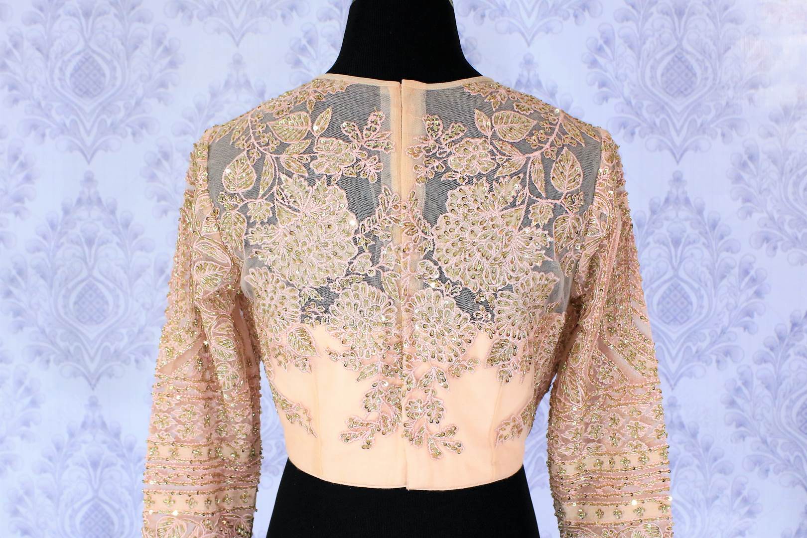 Sizzle like a princess in our exquisitely designed blush pink designer saree blouse with floral embroidery sheer net full sleeve details. The intricately handcrafted modern blouse is your go-to wedding and party must-have. Shop beautiful designer blouses online or visit Pure Elegance store in USA. -back