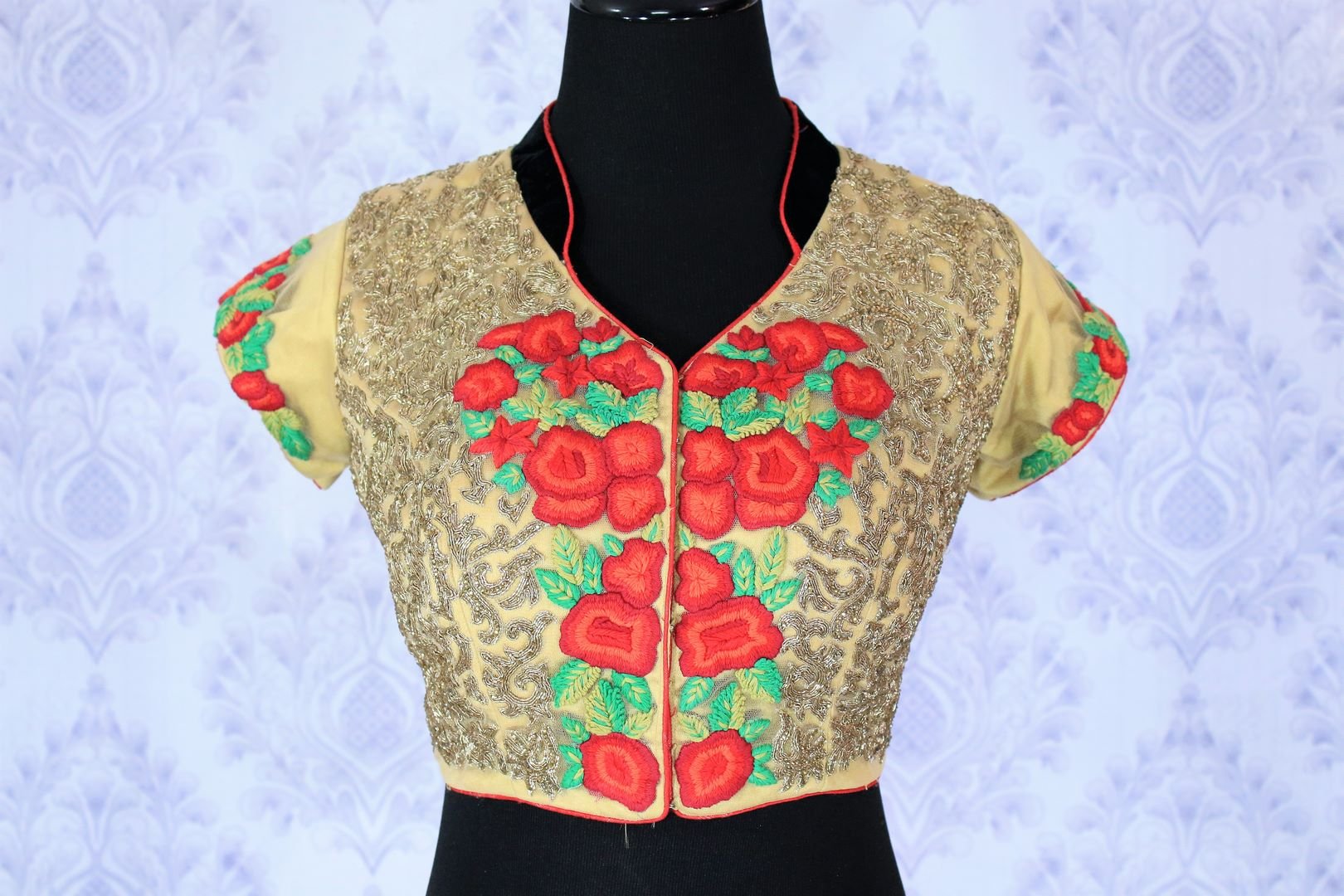 Up your fashion appeal in this aesthetically pleasing beige floral embroidered designer blouse. The melange of red and green floral hues with a keyhole at back creates quite a stunning look. Shop such beautiful blouses online or visit Pure Elegance store in USA.-front