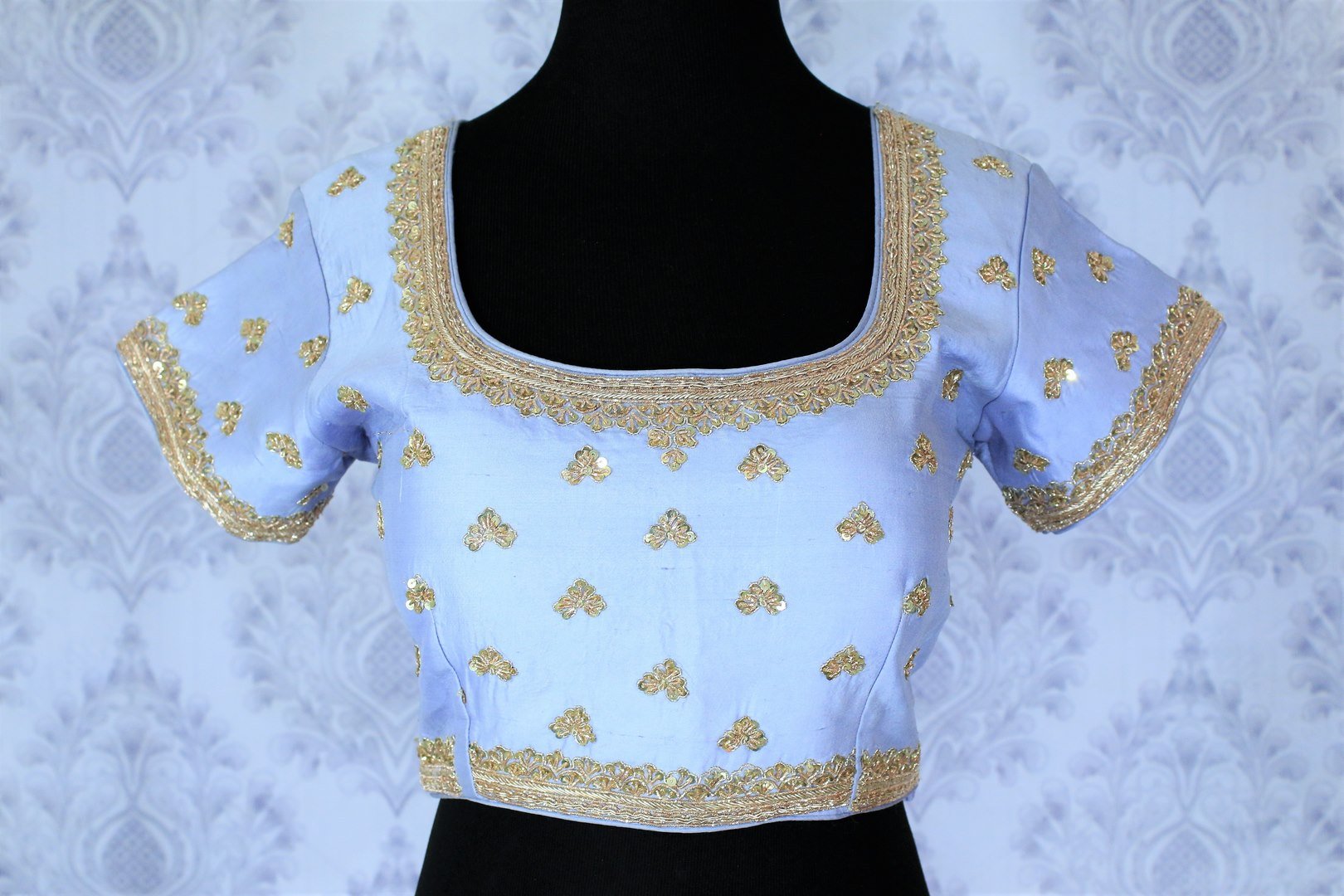 This celebrity-inspired powder blue coloured pastel blouse with stunning gold embroidery is quite a tempting bait. The wide keyhole with tassels hanging at the back further create drama and add grace to the feminine look. Shop beautifully handcrafted blouses online or visit Pure Elegance store in USA.-front