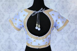 This celebrity-inspired powder blue coloured pastel blouse with stunning gold embroidery is quite a tempting bait. The wide keyhole with tassels hanging at the back further create drama and add grace to the feminine look. Shop beautifully handcrafted blouses online or visit Pure Elegance store in USA.-back