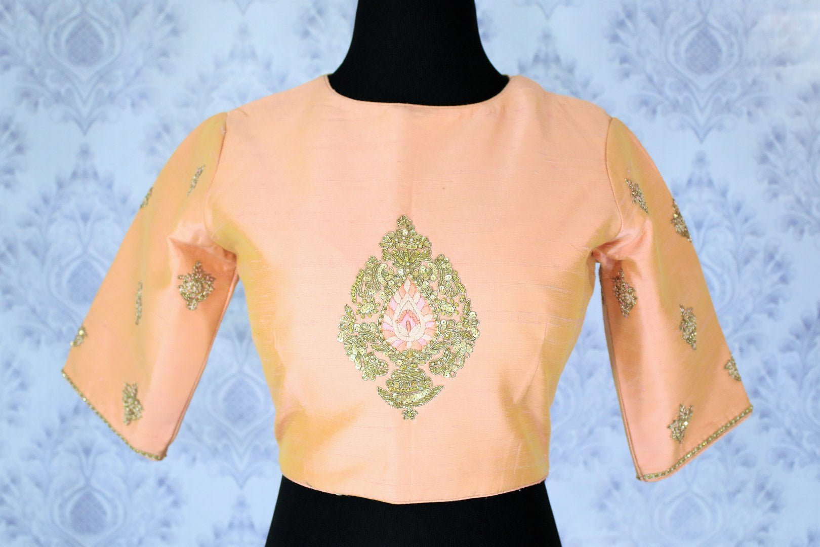 Steal the hearts away in this oh-so-feminine yet trendy pastel pink gold embroidered sari blouse. The minimal yet visually appealing designer blouse is a perfect bet to style with a stunning bright or contrasting saree. Shop elegantly tailored blouses online or visit Pure Elegance store in USA. -front