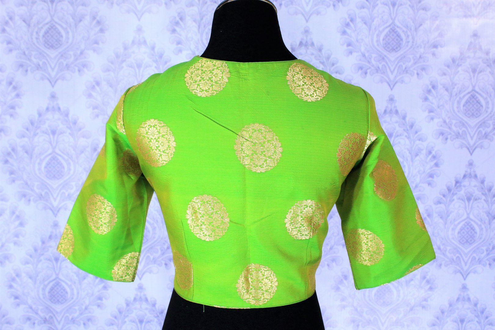 Lift your spirits as you doll up in this exclusively designed green with gold floral motifs silk saree blouse. This showstopper designer blouse will look strikingly beautiful with a black sari. Shop traditional blouses online or visit Pure Elegance store in USA. -back