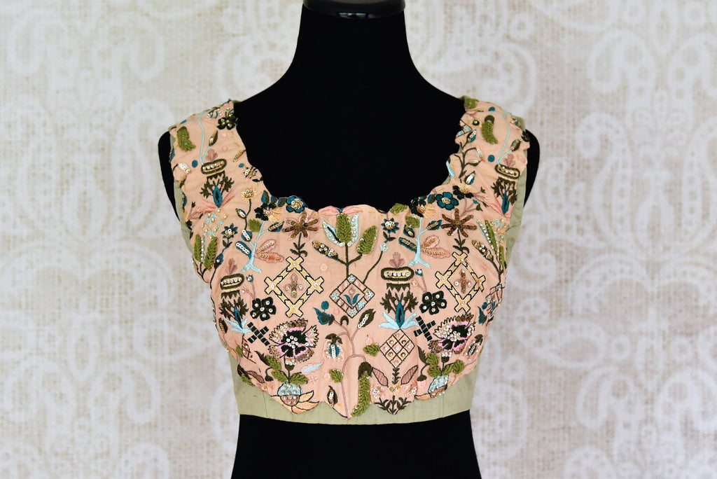 Buy green and peach embroidered sleeveless saree blouse online in USA. Match your saree with exquisite designer sari blouses from Pure Elegance clothing store in USA. Shop now at our store or visit online.-front