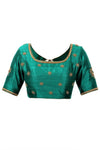 Buy emerald green raw silk embroidered sari blouse online in USA with 3/4th sleeves. Find the right matching saree blouses for your designer sarees at Pure Elegance online store. We have an alluring collection of readymade sari blouses at our exclusive fashion store in USA. Shop now.-front