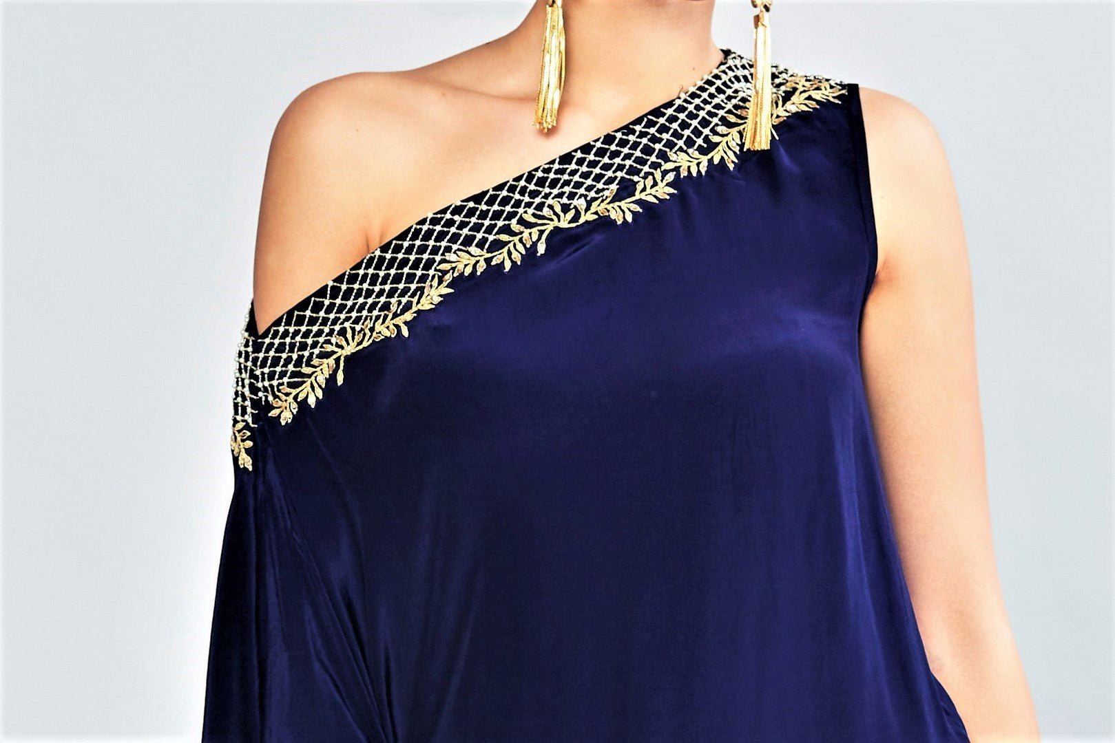 Shop navy blue asymmetric top with blush pink pants online in USA. Elevate your Indian style with a range of exclusive Indian designer dresses from Pure Elegance clothing store in USA. We have an exquisite collection of Indian sarees, suits, Anarkalis, lehengas for Indian women living in USA. Shop now.-top