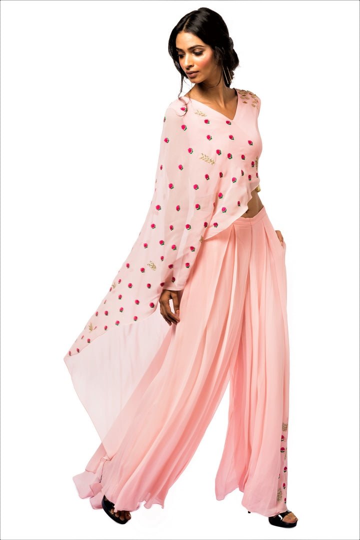 Shop pink embroidered crop top with drape online in USA and palazzo. Make a dazzling style statement at parties, weddings and festive occasions with a range of exquisite designer dresses, designer gowns, wedding lehengas available at Pure Elegance Indian clothing store in USA or on our online store.-full view