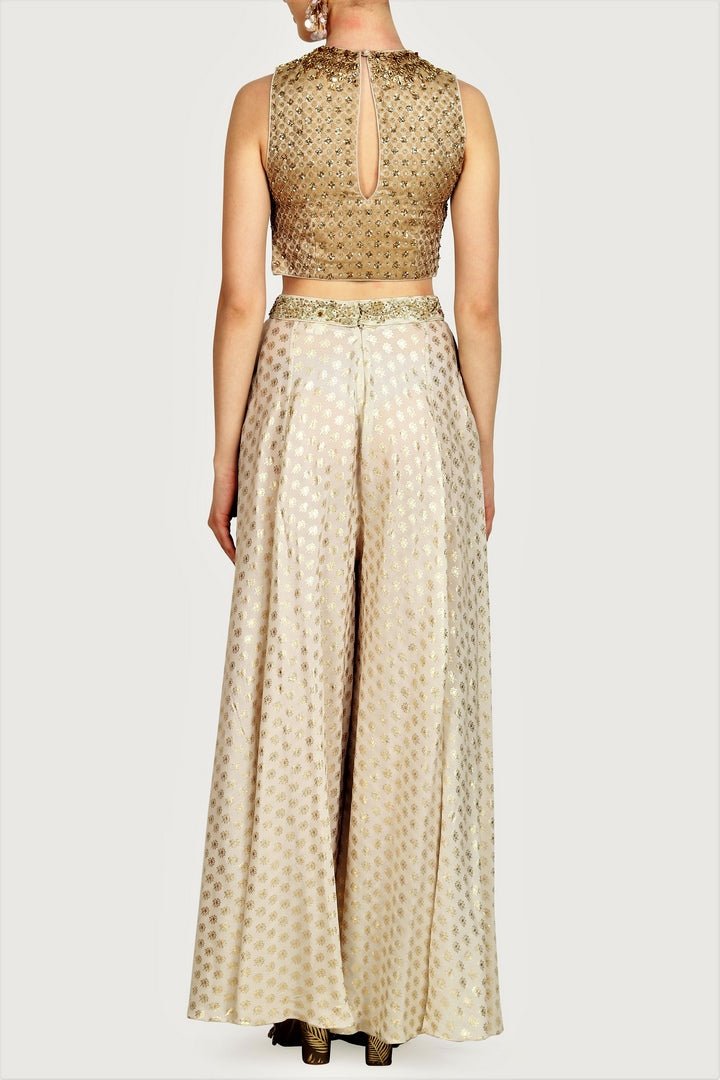 Buy gold brocade embroidered crop top with foil print sharara online in USA. For more such gorgeous designer dresses, shop at Pure Elegance Indian fashion store in USA. A beautiful range of traditional sarees and designer clothing is available for Indian women living in USA. You can also shop at our online store.-back