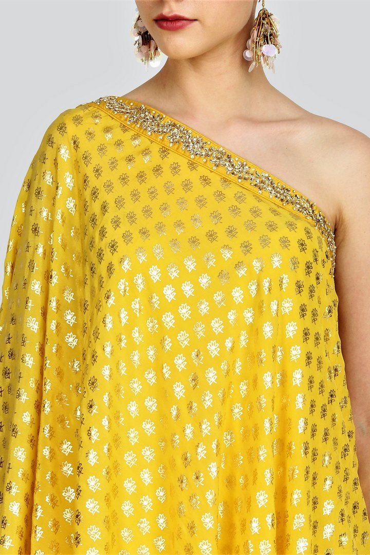 Shop yellow one-shoulder embroidered top with dhoti pants online in USA. For more such gorgeous designer dresses, shop at Pure Elegance Indian fashion store in USA. A beautiful range of traditional Indian sarees and designer clothing is available for Indian women living in USA. You can also shop at our online store.-top
