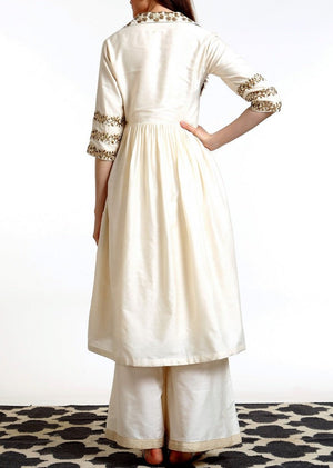 Buy ivory hand embroidered silk blend tunic with matching palazzo online in USA. Get occasion ready with a stunning range of Indian designer dresses from Pure Elegance fashion store in USA. Shop from a collection of designer suits, wedding sarees, wedding lehengas and Indian clothing for a gorgeous ethnic look from our online store.-back