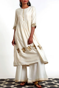 Shop ivory color hand embroidered silk blend tunic with matching palazzo online in USA. Get occasion ready with a stunning range of Indian designer dresses from Pure Elegance fashion store in USA. Shop from a collection of designer suits, wedding lehengas and Indian clothing for a gorgeous ethnic look from our online store.-full view