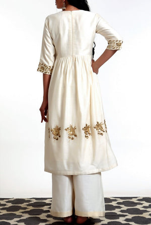 Shop ivory color hand embroidered silk blend tunic with matching palazzo online in USA. Get occasion ready with a stunning range of Indian designer dresses from Pure Elegance fashion store in USA. Shop from a collection of designer suits, wedding lehengas and Indian clothing for a gorgeous ethnic look from our online store.-back