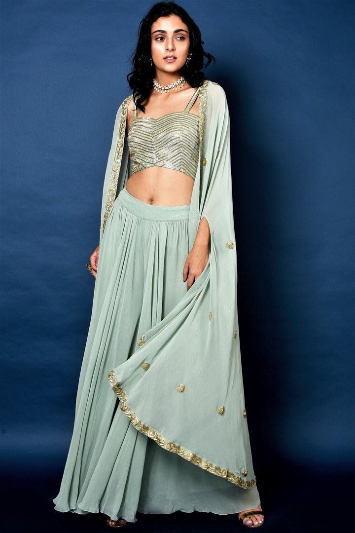 Shop sage green flared pants with embroidered blouse and cape online in USA. Elevate your ethnic style with a stunning range of Indian designer dresses from Pure Elegance Indian fashion store in USA. You can also shop the same collection from our online store.-full view