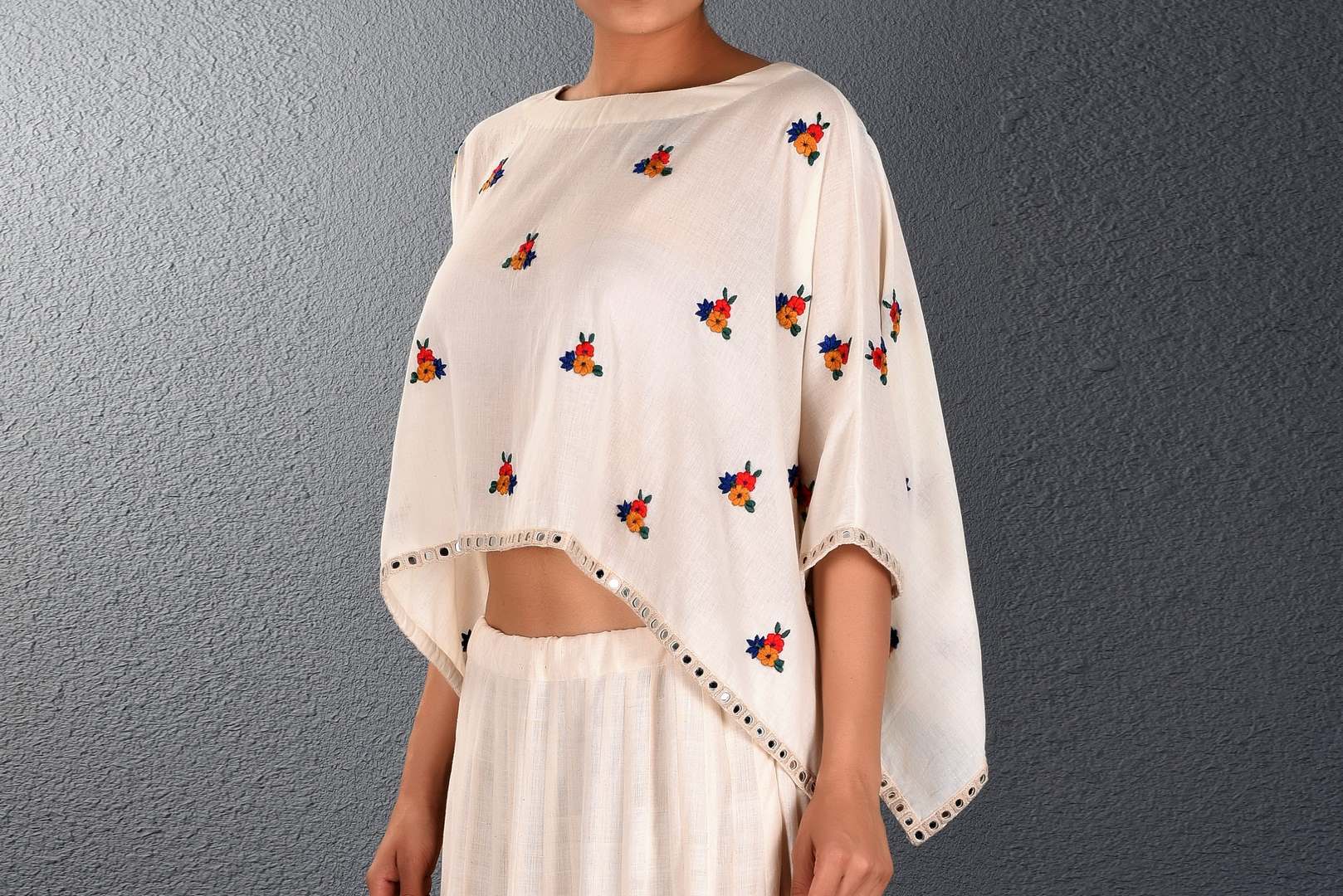 Shop off-white parsi and mirror embroidery poncho with skirt online in USA. Pick your favorite Indian dresses from Pure Elegance clothing store in USA. Step up your style with a range of Indian designer dresses, suits, designer lehengas also available on our online store. -top
