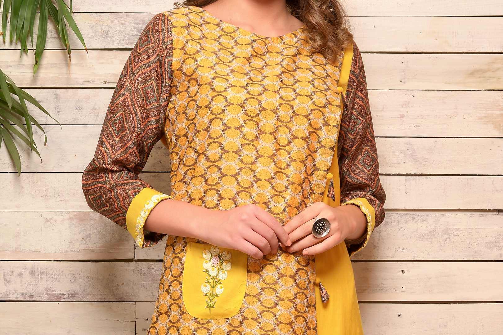 Buy yellow Angrakha style cotton silk kurta with matching pants online in USA. Pick your favorite Indian designer suits and dresses from Pure Elegance clothing store in USA. Make your ethnic collection complete with a range of Indian saris, Anarkali suits, designer lehengas also available on our online store.  -top