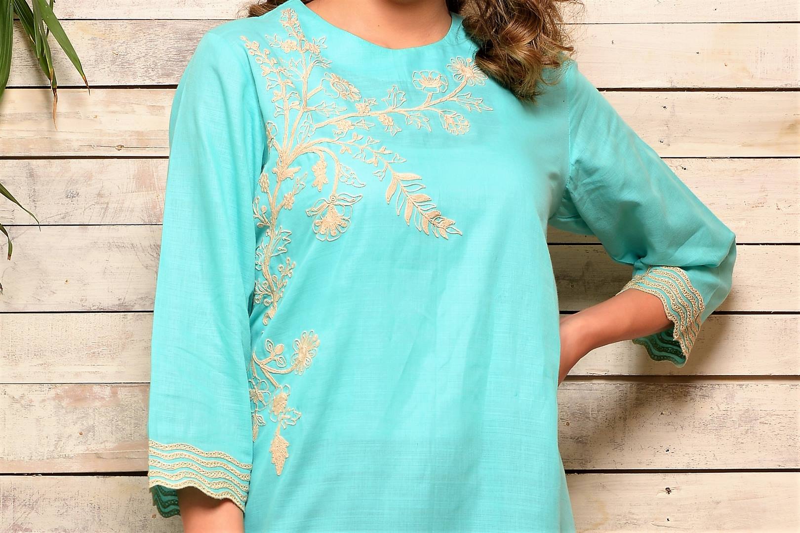 Buy aqua blue embroidered cotton kurta with grey pants online in USA. Pick your favorite Indian designer suits and dresses from Pure Elegance clothing store in USA. Make your ethnic collection complete with a range of Indian sarees, Anarkali suits, designer lehengas also available on our online store. -top