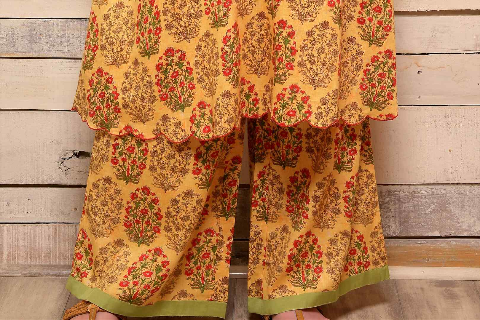 Shop yellow printed cotton kurta with palazzo online in USA and green embroidered scarf. Pick your favorite Indian designer suits and dresses from Pure Elegance clothing store in USA. Make your ethnic collection complete with a range of Indian sarees, Anarkali suits, designer lehengas also available on our online store.  -bottom