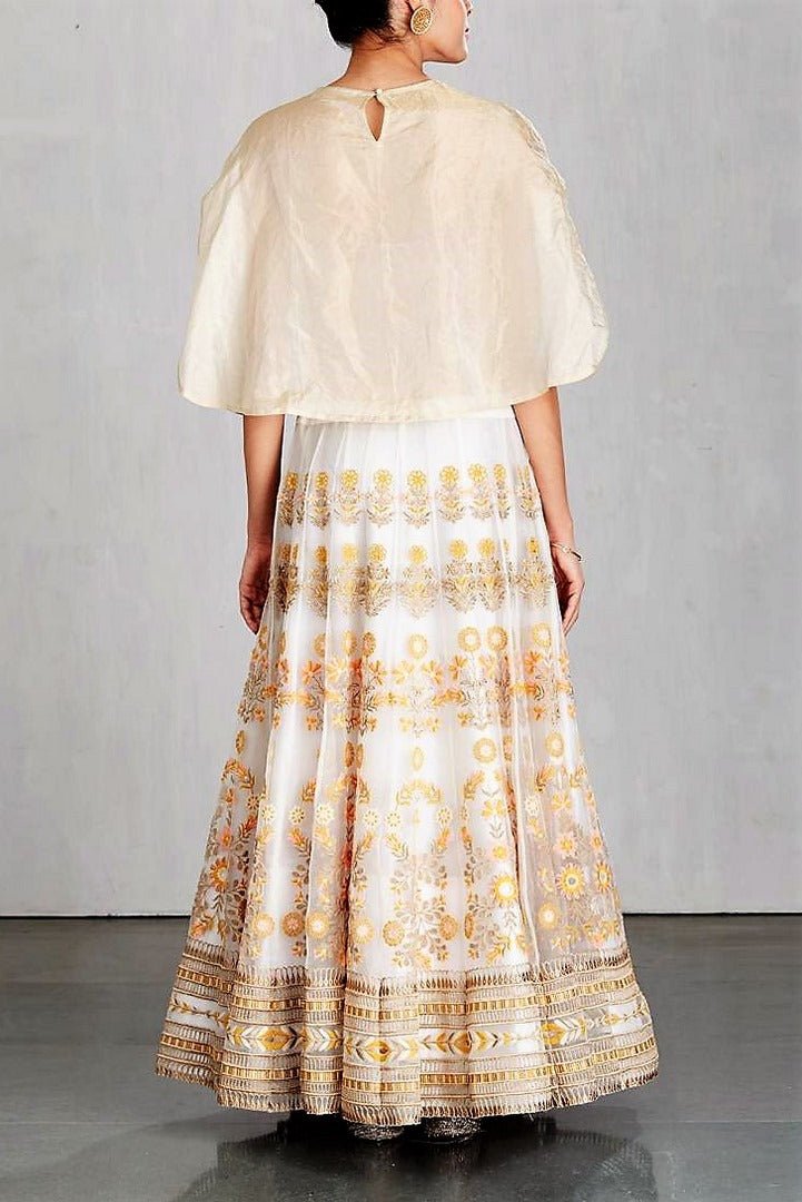 Buy ivory color embroidered cape with embroidered skirt online in USA. Make a captivating fashion statement with a range of Indian designer dresses from Pure Elegance clothing store in USA. If you are looking for online shopping, then look to our online store for a stunning collection of designer lehengas, Indian clothing and much more.-back