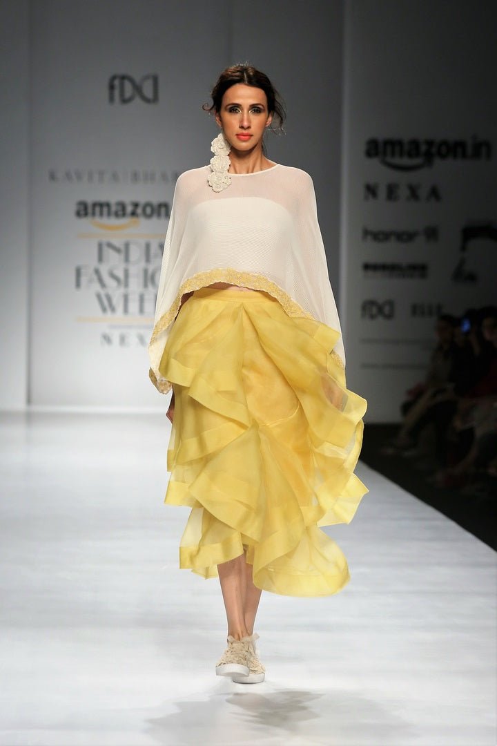 Buy off-white embroidered chiffon top with yellow tiered skirt online in USA. Make a captivating fashion statement with a range of designer dresses from Pure Elegance clothing store in USA. If you are looking for Indian designer clothes online, then look to our online store for a stunning collection of Anarkali dresses, wedding lehengas and much more.-front