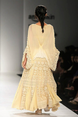 Shop beige ombre poncho with thread embroidery skirt online in USA. Make a captivating fashion statement with a range of designer dresses from Pure Elegance clothing store in USA. If you are looking for Indian designer clothes online, then look to our online store for a stunning collection of Anarkali dresses, wedding lehengas and much more.-back