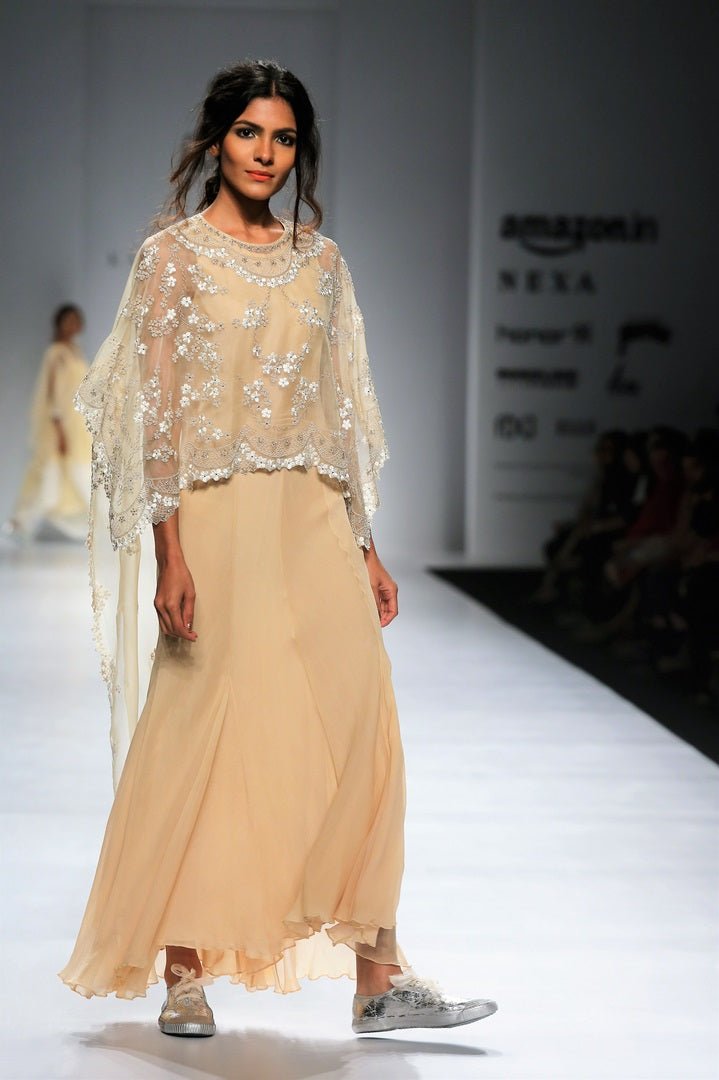 Buy beige embroidered hi-low cape with chiffon hi-low dress online in USA. Make a captivating fashion statement with a range of designer dresses from Pure Elegance clothing store in USA. If you are looking for Indian designer clothes online, then look to our online store for a stunning collection of Anarkali dresses, wedding lehengas and much more.-side