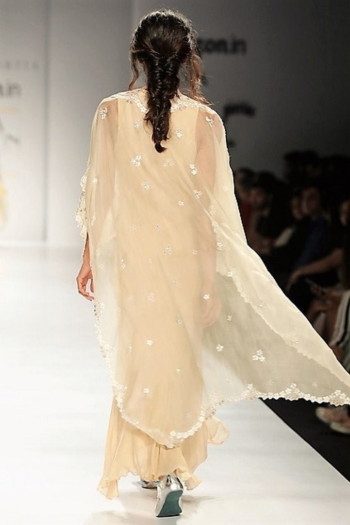 Buy beige embroidered hi-low cape with chiffon hi-low dress online in USA. Make a captivating fashion statement with a range of designer dresses from Pure Elegance clothing store in USA. If you are looking for Indian designer clothes online, then look to our online store for a stunning collection of Anarkali dresses, wedding lehengas and much more.-back
