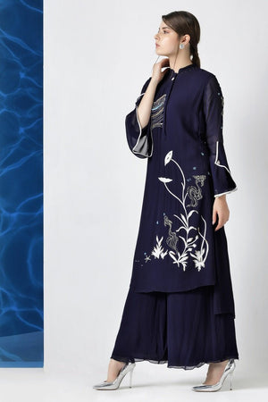 Shop designer navy embroidered hi-low kurta with palazzo online in USA at Pure Elegance. Make your wardrobe an eclectic mix of alluring silhouettes and colors with a range of Indian designer clothes available at our clothing store in USA. -side