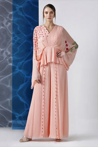 Buy powder pink embroidered jumpsuit with exaggerated sleeves online in USA from Pure Elegance. Make your wardrobe an eclectic mix of alluring silhouettes and colors with a range of Indian designer clothes available at our clothing store in USA. -full view