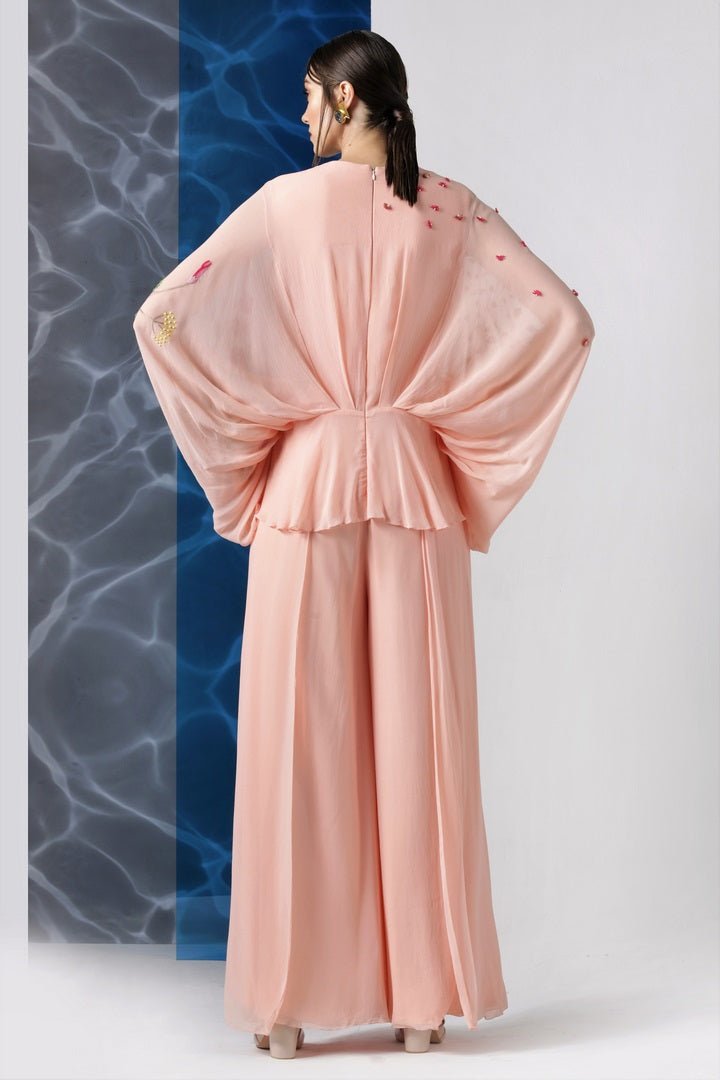 Buy powder pink embroidered jumpsuit with exaggerated sleeves online in USA from Pure Elegance. Make your wardrobe an eclectic mix of alluring silhouettes and colors with a range of Indian designer clothes available at our clothing store in USA. -back