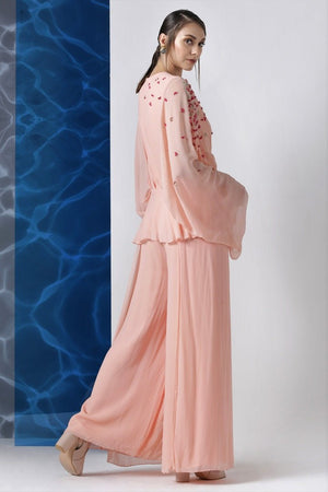 Buy powder pink embroidered jumpsuit with exaggerated sleeves online in USA from Pure Elegance. Make your wardrobe an eclectic mix of alluring silhouettes and colors with a range of Indian designer clothes available at our clothing store in USA. -side