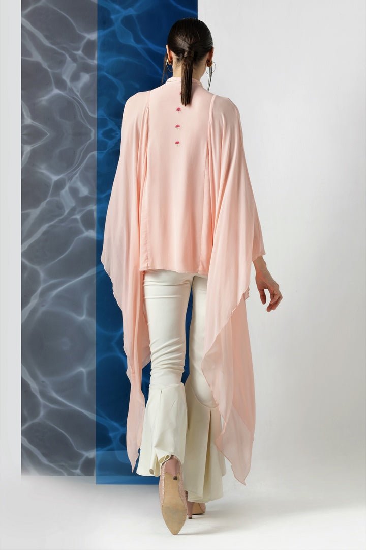 Shop powder pink embroidered top with exaggerated sleeves online in USA at Pure Elegance. Make your wardrobe an eclectic mix of alluring silhouettes and colors with a range of Indian designer clothes available at our clothing store in USA. -back