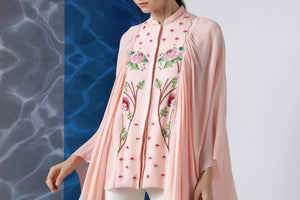 Shop powder pink embroidered top with exaggerated sleeves online in USA at Pure Elegance. Make your wardrobe an eclectic mix of alluring silhouettes and colors with a range of Indian designer clothes available at our clothing store in USA. -top