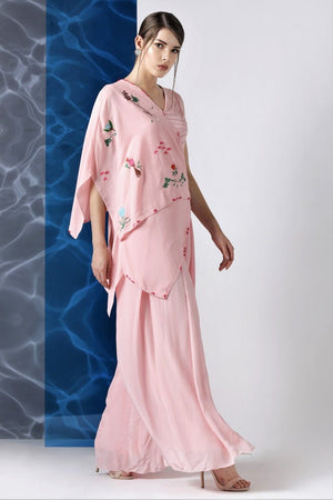 Buy powder pink embroidered jumpsuit with one shoulder drape online in USA at Pure Elegance. Make your wardrobe an eclectic mix of alluring silhouettes and colors with a range of Indian designer clothes available at our clothing store in USA. -side