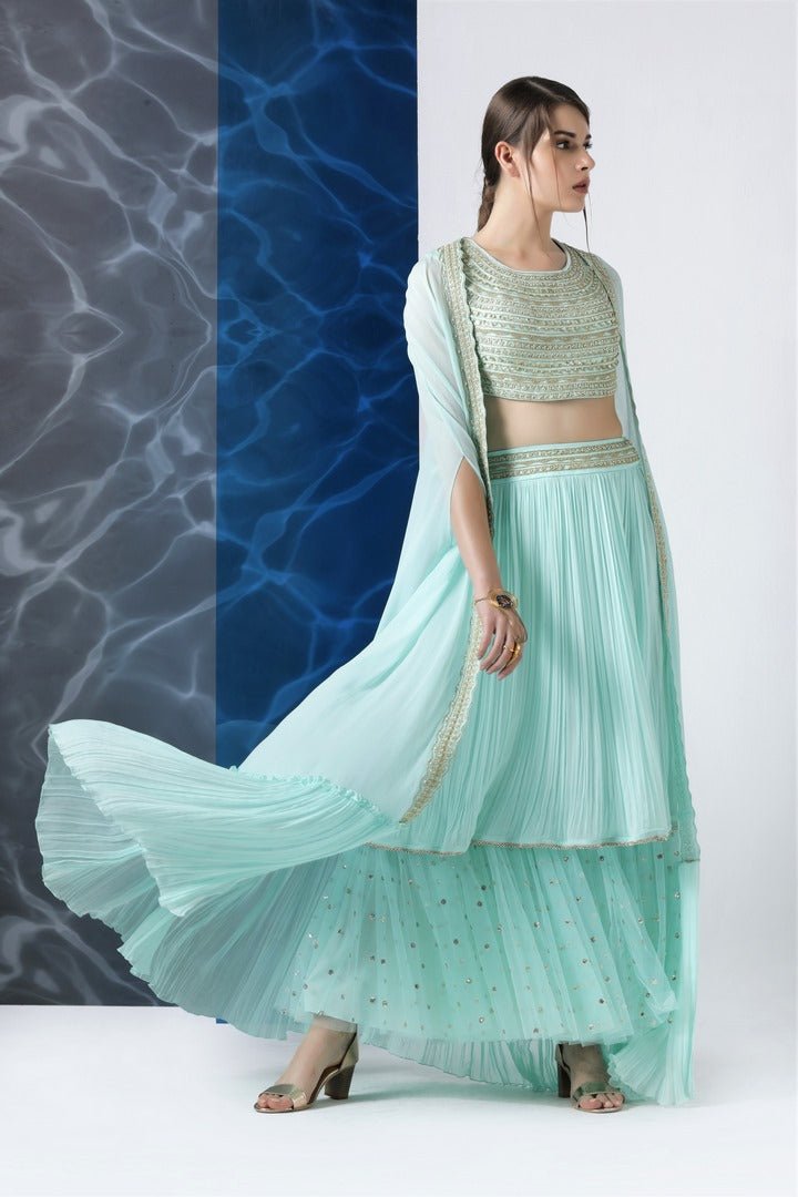 Buy mint embroidered crop top with layered skirt and cape online in USA from Pure Elegance. Make your wardrobe an eclectic mix of alluring silhouettes and colors with a range of Indian designer clothing available at our clothing store in USA. -full view