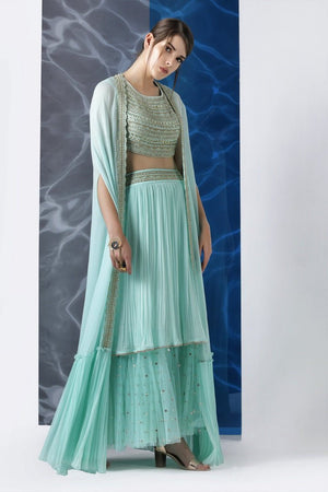 Buy mint embroidered crop top with layered skirt and cape online in USA from Pure Elegance. Make your wardrobe an eclectic mix of alluring silhouettes and colors with a range of Indian designer clothing available at our clothing store in USA. -side