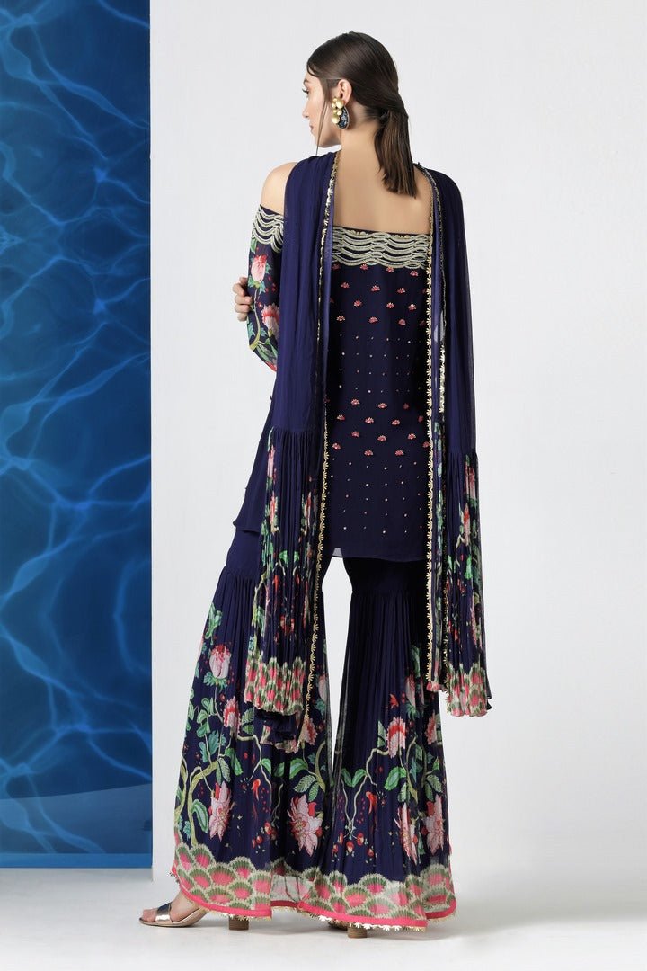 Buy navy embroidered off shoulder kurti with sharara and dupatta online in USA from Pure Elegance. Make your wardrobe an eclectic mix of alluring silhouettes and colors with a range of Indian designer clothing available at our clothing store in USA. -back