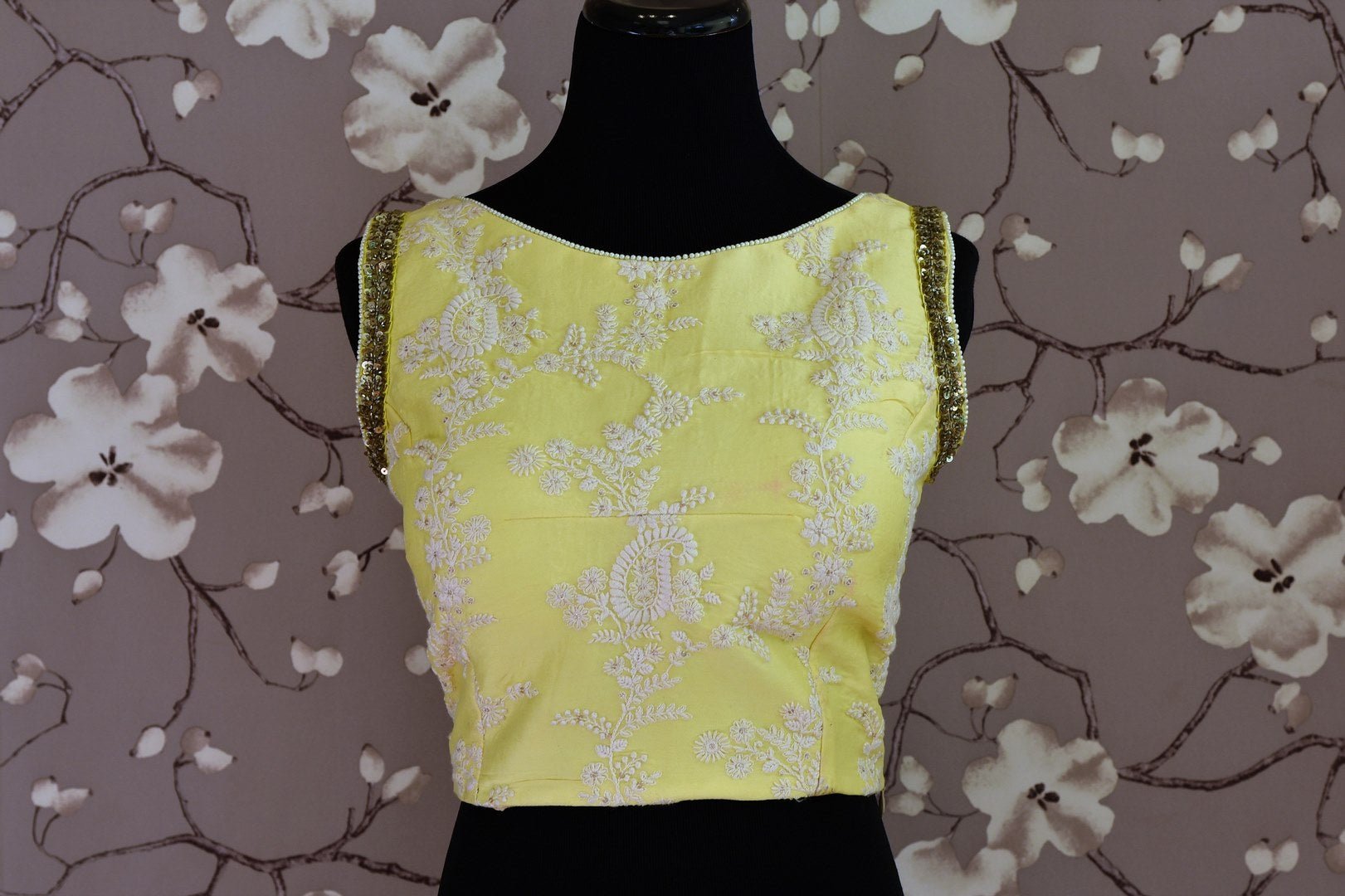 Shop lemon yellow embroidered silk sleeveless saree blouse online in USA. Score a perfect ten for your saree look with exquisite designer saree blouses from Pure Elegance Indian fashion store in USA. Shop now.-front