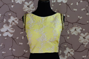 Shop lemon yellow embroidered silk sleeveless saree blouse online in USA. Score a perfect ten for your saree look with exquisite designer saree blouses from Pure Elegance Indian fashion store in USA. Shop now.-front