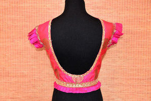 Shop pink embroidered Banarasi saree blouse online in USA with frill sleeves. Elevate your ethnic saree style with a tasteful collection of designer saree blouses from Pure Elegance Indian clothing store in USA.-back