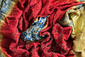 Buy beautiful red and yellow bandhej gajji silk dupatta online in USA with Ajrakh print. Choose from an exclusive collection of Indian designer suits, Anarakali dresses, palazzo suits, salwar suits, designer gowns, readymade dupatta, sharara suits from Pure Elegance Indian clothing store in USA.-closeup