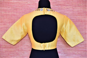 Shop lovely lemon yellow embroidered Banarasi saree blouse online in USA with cutout back. Complete your Indian sarees with exquisite readymade saree blouse from Pure Elegance Indian clothing store in USA.-back