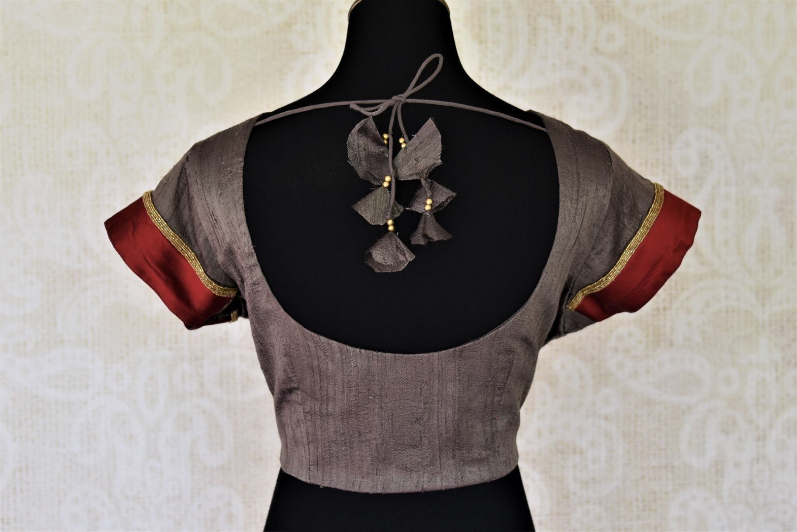 Shop dark grey silk sari saree blouse online in USA with red border on sleeves. Complete your ethnic saree look with designer blouses, readymade sari blouse, embroidered saree blouse from Pure Elegance Indian saree store in USA.-back