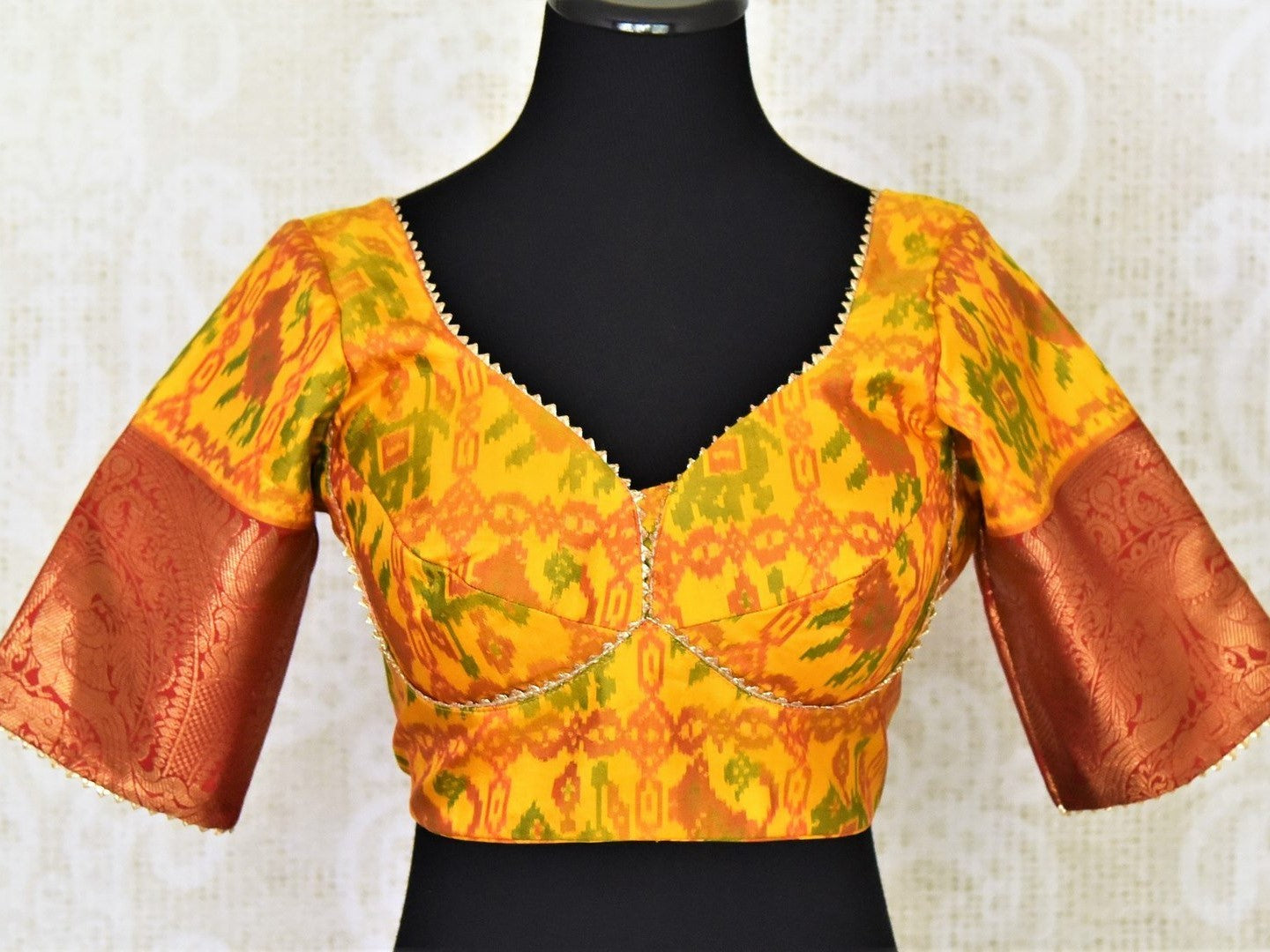 Buy beautiful yellow ikkat saree blouse online in USA with red zari sleeves. Go for a perfect saree style with latest designer saree blouses, pure silk blouse, choli-cut saree blouses, readymade sarees blouse, padded saree blouses from Pure Elegance Indian saree store in USA.-full view