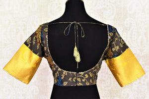 Shop beautiful dark grey Kalamkari silk saree blouse online in USA with yellow zari sleeves. Go for a perfect saree style with latest designer saree blouses, pure silk blouse, choli-cut saree blouses, readymade sarees blouse, padded saree blouses from Pure Elegance Indian saree store in USA.-back