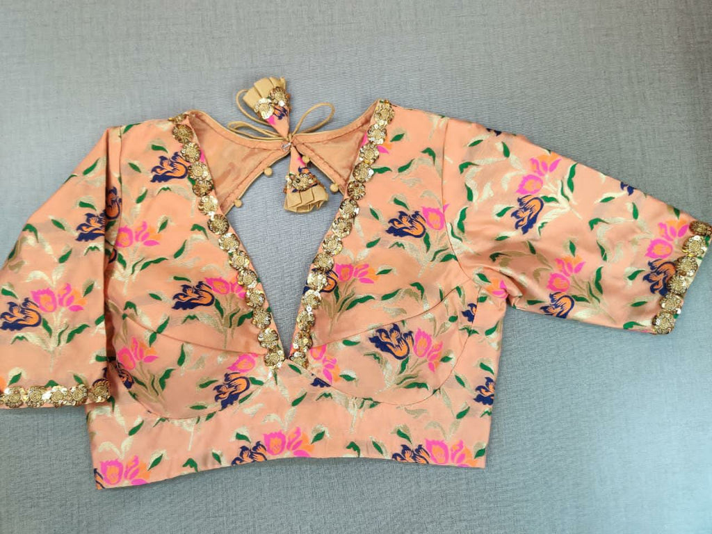 Shop gorgeous peach embroidered neckline Banarasi saree blouse online in USA. Elevate your Indian ethnic saree looks with beautiful readymade saree blouse, embroidered sari blouses, Banarasi saree blouse, designer sari from Pure Elegance Indian fashion store in USA.-front