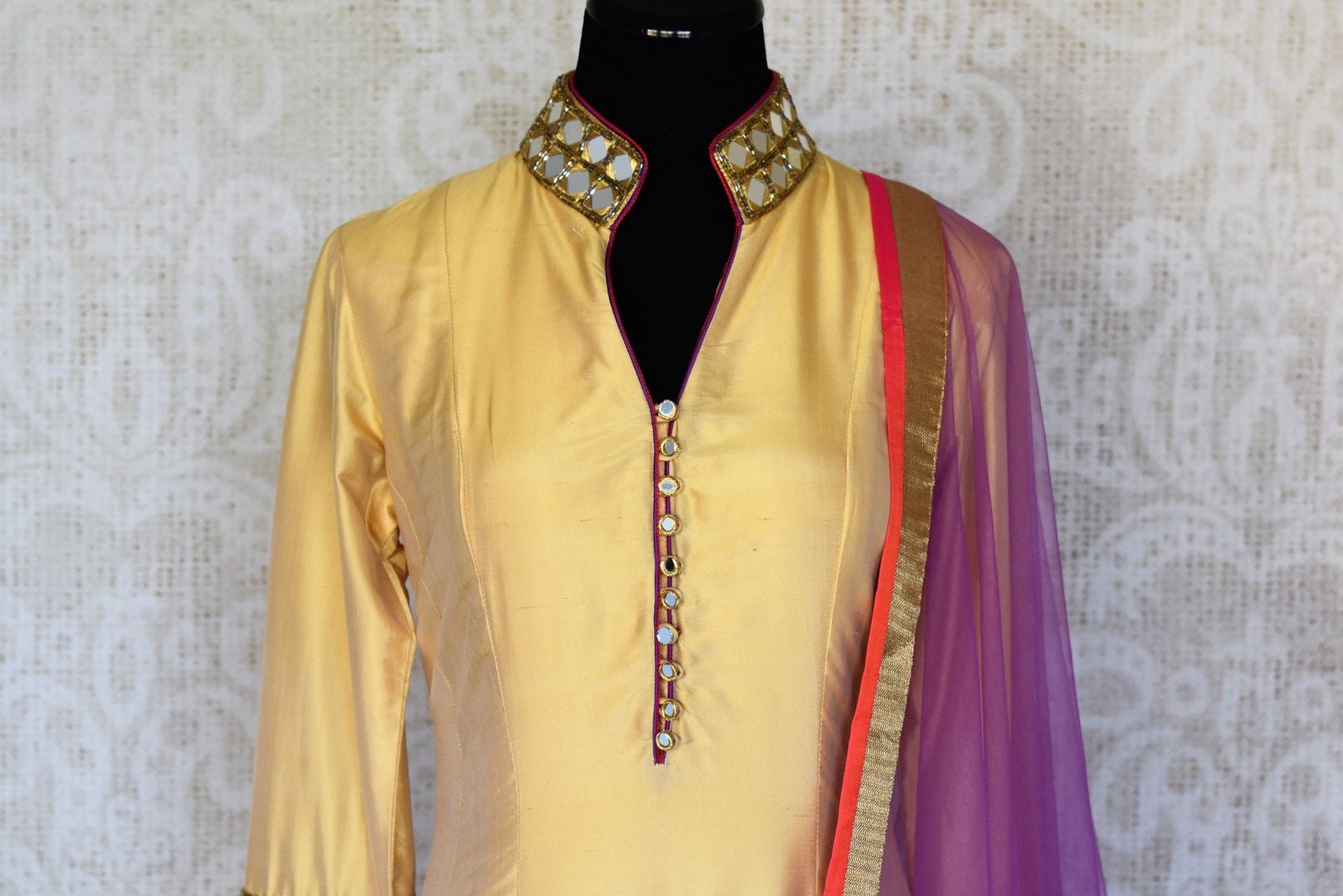 Buy beige and red silk suit online in USA with purple dupatta and mirror work from Pure Elegance. Choose from a range of exclusive Indian designer suits, wedding dresses, Anarkali suits in beautiful styles and designs from our Indian fashion store in USA and flaunt your tasteful sartorial choices on special occasions.-front
