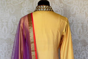 Buy beige and red silk suit online in USA with purple dupatta and mirror work from Pure Elegance. Choose from a range of exclusive Indian designer suits, wedding dresses, Anarkali suits in beautiful styles and designs from our Indian fashion store in USA and flaunt your tasteful sartorial choices on special occasions.-back