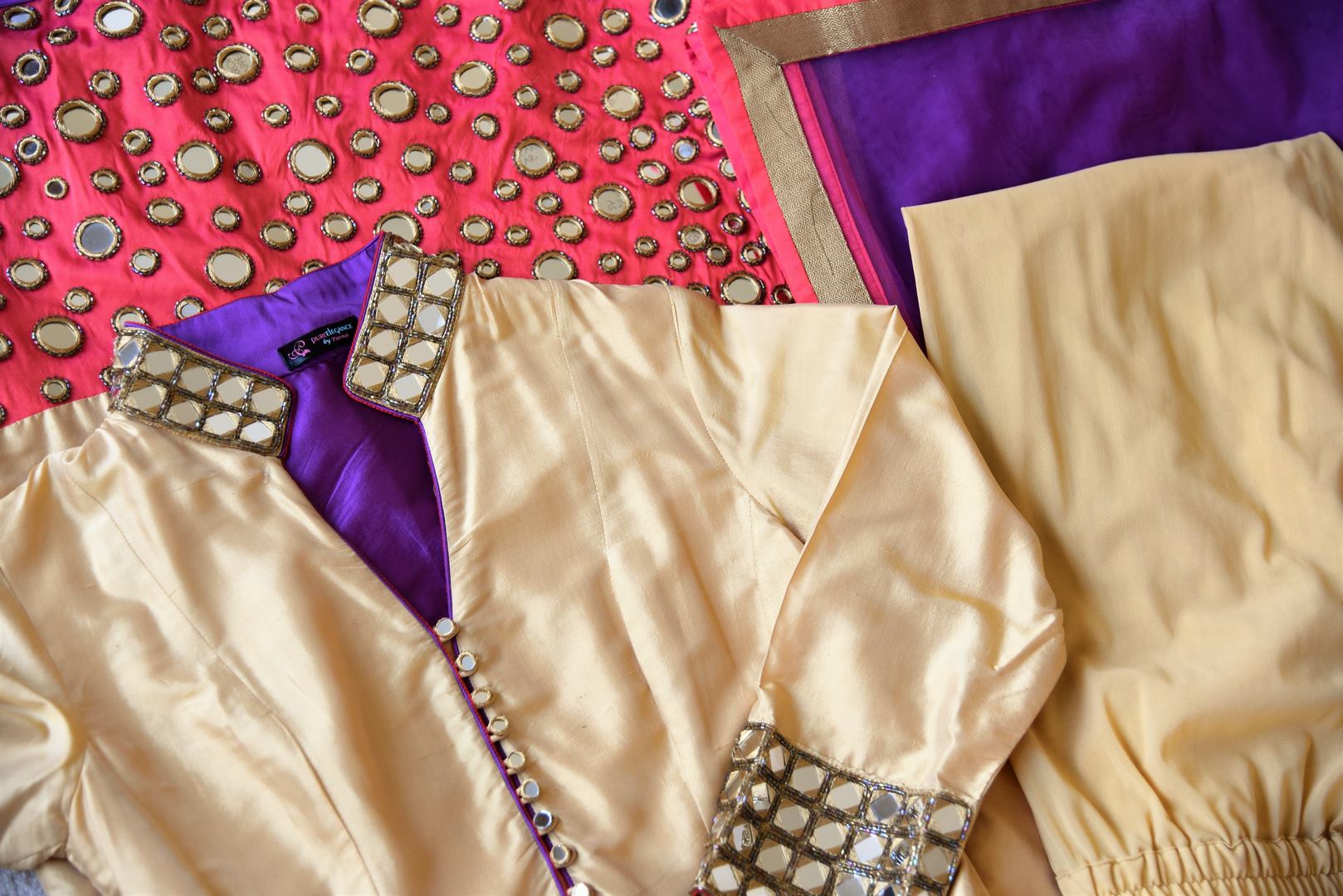 Buy beige and red silk suit online in USA with purple dupatta and mirror work from Pure Elegance. Choose from a range of exclusive Indian designer suits, wedding dresses, Anarkali suits in beautiful styles and designs from our Indian fashion store in USA and flaunt your tasteful sartorial choices on special occasions.-details