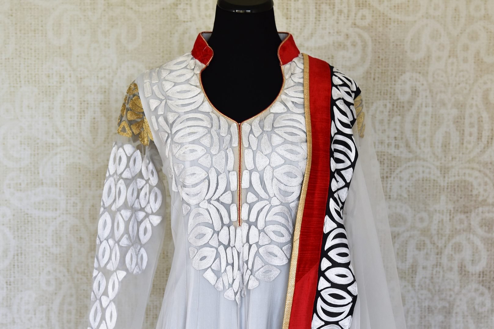 Buy white embroidered net Anarkali suit online in USA with red and black border from Pure Elegance. Choose from a range of exclusive Indian designer suits, wedding dresses, Anarkali suits in beautiful styles and designs from our Indian fashion store in USA and flaunt your tasteful sartorial choices on special occasions.-front