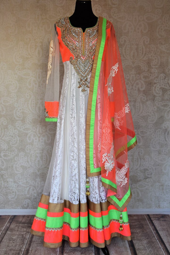 Buy white embroidered net floor length Anarkali suit online in USA with orange and green border from Pure Elegance. Choose from a range of exclusive Indian designer suits, wedding dresses, Anarkali suits in beautiful styles and designs from our Indian fashion store in USA and flaunt your tasteful sartorial choices on special occasions.-full view
